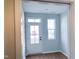 Entryway featuring a glass front door, wood-look floors, and natural light at 2335 Whitewing Ln, Wendell, NC 27591