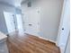 Hallway with wood-look floors, neutral paint, closet and doorways to bedrooms at 2335 Whitewing Ln, Wendell, NC 27591