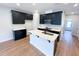 New kitchen featuring dark cabinets, quartz countertops, and stainless steel appliances at 2335 Whitewing Ln, Wendell, NC 27591
