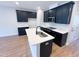 New kitchen featuring dark cabinets, quartz countertops, and stainless steel appliances at 2335 Whitewing Ln, Wendell, NC 27591