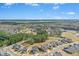 Aerial view of a residential neighborhood with lush trees and a lake at 26 Stone Bridge Xing, Chapel Hill, NC 27517