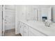 Bathroom with white vanity with double sinks, adjacent to a bathtub and shower at 26 Stone Bridge Xing, Chapel Hill, NC 27517