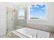 Bright bathroom featuring a separate tub and shower with a window providing natural light at 26 Stone Bridge Xing, Chapel Hill, NC 27517