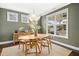 Stylish dining room with a modern light fixture, ample natural light, and seating for four at 26 Stone Bridge Xing, Chapel Hill, NC 27517