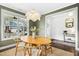 Bright dining area with a decorative centerpiece, three windows, and hardwood floors at 26 Stone Bridge Xing, Chapel Hill, NC 27517