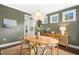Cozy dining area with a modern chandelier, decorative flowers, and access to the kitchen at 26 Stone Bridge Xing, Chapel Hill, NC 27517