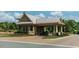 Elegant gated entrance features a covered entry with stone accents and well-manicured landscaping at 26 Stone Bridge Xing, Chapel Hill, NC 27517