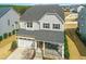 Aerial shot of a two-story home featuring a front porch, two-car garage, and manicured landscaping at 26 Stone Bridge Xing, Chapel Hill, NC 27517