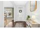 Bright and inviting foyer with hardwood floors, a decorative mirror, and elegant console table at 26 Stone Bridge Xing, Chapel Hill, NC 27517