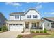 Charming two-story home with stone accents, covered porch, attached garage, and well-maintained landscaping at 26 Stone Bridge Xing, Chapel Hill, NC 27517
