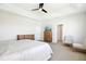 Spacious main bedroom with tray ceiling, ceiling fan, dresser, TV, and sitting area at 26 Stone Bridge Xing, Chapel Hill, NC 27517