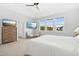 Main bedroom with two TVs, and seating beneath large windows with neighborhood view at 26 Stone Bridge Xing, Chapel Hill, NC 27517