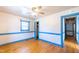 Classic bedroom with white walls, hardwood floors, ceiling fan, and blue trim accents at 2608 Walley St, Rocky Mount, NC 27803