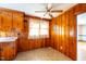 Cozy kitchen with wood paneled walls, ceiling fan, and breakfast nook with natural light at 2608 Walley St, Rocky Mount, NC 27803