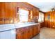 A cozy kitchen with wooden cabinets, a bright window over the sink, and vinyl flooring at 2608 Walley St, Rocky Mount, NC 27803