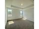Serene bedroom with plush carpeting, tray ceiling, and sun-filled windows at 338 Tormore Dr, Homesite 123, Sanford, NC 27330