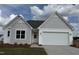 Charming single-Gathering home featuring a spacious two-car garage and a well-manicured front yard at 338 Tormore Dr, Homesite 123, Sanford, NC 27330