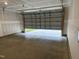 Spacious garage with an open overhead door, showing unfinished drywall and a concrete floor at 338 Tormore Dr, Homesite 123, Sanford, NC 27330