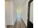 Inviting hallway with wood-look flooring leading to a bright living area with abundant natural light at 338 Tormore Dr, Homesite 123, Sanford, NC 27330
