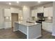 Modern kitchen with stainless steel appliances, white cabinets, and a granite-topped island at 338 Tormore Dr, Homesite 123, Sanford, NC 27330