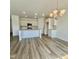Open kitchen and dining area featuring an island with granite countertops and modern lighting at 338 Tormore Dr, Homesite 123, Sanford, NC 27330