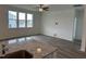 Open-concept living room with hardwood floors, bright windows, and an open concept view to the kitchen at 338 Tormore Dr, Homesite 123, Sanford, NC 27330