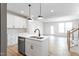 Bright kitchen featuring stainless steel appliances, modern white cabinets, and a central island sink at 357 Church St # 61, Wendell, NC 27591