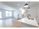 Open-concept living area with hardwood floors, natural light, and a view of the staircase at 357 Church St # 61, Wendell, NC 27591