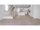 Open-concept space featuring stairs, a kitchen with stainless steel appliances, and hardwood floors at 357 Church St # 61, Wendell, NC 27591