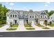 Charming street view of newly constructed townhomes with individual garages and landscaped front yards at 357 Church St # 61, Wendell, NC 27591