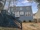 Exterior view of the backyard showcasing a deck and some landscaping at 3908 Sturbridge Dr, Durham, NC 27713