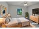 Bright bedroom featuring natural light, ceiling fan, and modern furniture at 3908 Sturbridge Dr, Durham, NC 27713
