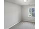 Cozy bedroom featuring a bright window with a view of the lush green trees outside at 3908 Sturbridge Dr, Durham, NC 27713