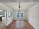 Open dining area with hardwood floors and a pendant light at 3908 Sturbridge Dr, Durham, NC 27713