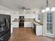 Well-lit kitchen featuring white cabinets, laminate countertops, stainless steel appliances, and hardwood floors at 3908 Sturbridge Dr, Durham, NC 27713