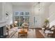 Bright living room with vaulted ceilings, fireplace, large windows, and modern staging at 3908 Sturbridge Dr, Durham, NC 27713