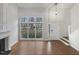 Bright living room featuring vaulted ceilings, fireplace, large windows, and hardwood floors at 3908 Sturbridge Dr, Durham, NC 27713