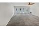 Expansive living room featuring multiple windows and neutral carpet at 3908 Sturbridge Dr, Durham, NC 27713