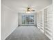 Bright living room with built in shelving, neutral carpet, and large window at 3908 Sturbridge Dr, Durham, NC 27713