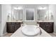 Bright bathroom featuring double sinks, a soaking tub, and neutral-toned countertops at 3924 Overcup Oak Ln, Cary, NC 27519