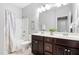 Bathroom featuring double vanity sinks, tiled floors, and shower-tub combo at 3924 Overcup Oak Ln, Cary, NC 27519
