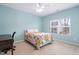 Bedroom with a floral quilt, natural light, and a desk at 3924 Overcup Oak Ln, Cary, NC 27519