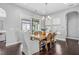 Cozy dining room featuring hardwood floors, chandelier lighting, and sliding door access to patio at 3924 Overcup Oak Ln, Cary, NC 27519