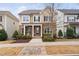 Charming two-story home featuring a stone facade, covered porch, and well-manicured landscaping at 3924 Overcup Oak Ln, Cary, NC 27519