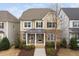 Two-story home with a stone facade, covered porch, neutral palette, and well-manicured landscaping at 3924 Overcup Oak Ln, Cary, NC 27519