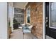 Exterior front porch featuring stone, a decorative screen panel, seating, and view of the front door at 3924 Overcup Oak Ln, Cary, NC 27519