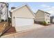 View of a detached 2-car garage, paved driveway, trimmed landscaping, and exterior lighting at 3924 Overcup Oak Ln, Cary, NC 27519