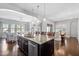 Open-concept kitchen with island seating, stainless steel appliances, and easy access to living spaces at 3924 Overcup Oak Ln, Cary, NC 27519