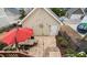 Aerial view of backyard patio with stone pavers, an outdoor dining table, shade umbrella, and well-kept landscaping at 3924 Overcup Oak Ln, Cary, NC 27519