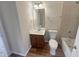 Cozy bathroom featuring a bathtub, toilet, sink with vanity, and a mirror at 4 Strowd Ct, Durham, NC 27703